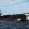 Two tug boats help to move the aircraft carrier USS Carl Vinson Poster Print by Stocktrek Images (34 x 22) view 1